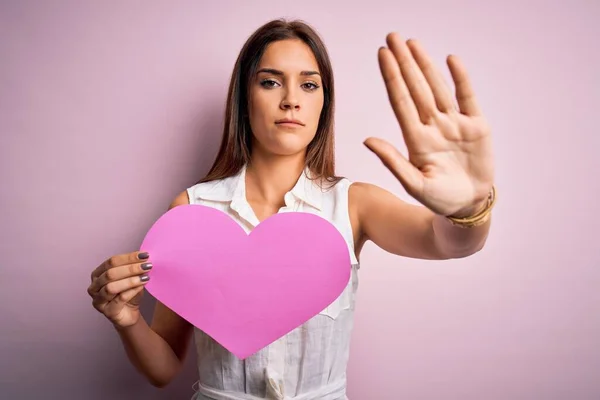 Young Beautiful Brunette Woman Holding Big Pink Heart Paper Celebrating — 스톡 사진