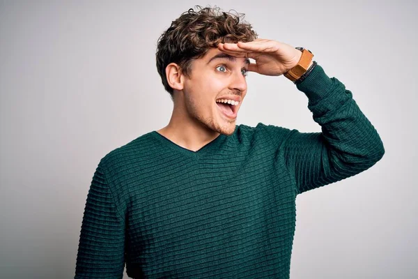 Young Blond Handsome Man Curly Hair Wearing Green Sweater White — Stockfoto