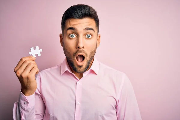 Young Handsome Businessman Holding Piece Puzzle Isolated Pink Background Scared — Stok fotoğraf