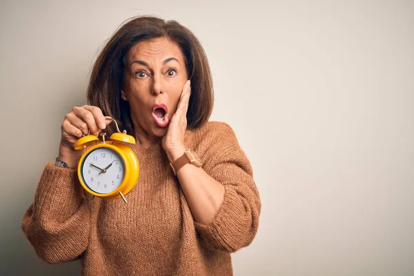 Brünette Frau Mittleren Alters Mit Klassischem Wecker Über Isoliertem Hintergrund — Stockfoto