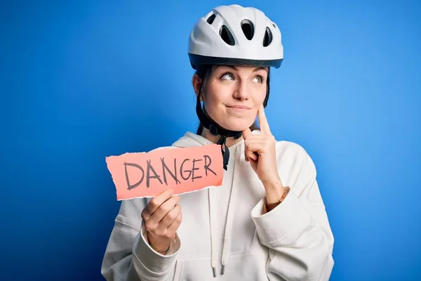 Young Beautiful Redhead Cyclist Woman Wearing Bike Helmet Holding Danger — Stock Photo, Image