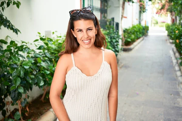 Young beautiful woman at the colorful village of Puerto de Mogan, smiling happy at the street on summer holidays