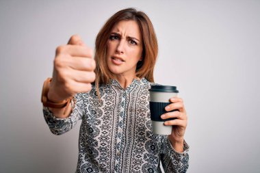 Young beautiful brunette woman drinking glass of takeaway coffe over white background annoyed and frustrated shouting with anger, crazy and yelling with raised hand, anger concept