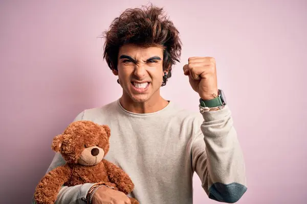 Young Handsome Man Holding Teddy Bear Standing Isolated Pink Background — Stockfoto