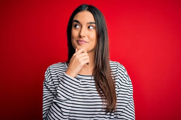 Young Beautiful Brunette Woman Wearing Casual Striped Shirt Red Background — Stockfoto