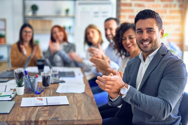 Group of business workers smiling happy and confident. Working together with smile on face looking at the camera applauding at the office