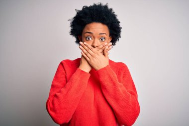 Kıvırcık saçlı, kırmızı kazak giyen güzel Afro-Amerikan kadın ağzını yanlışlıkla elleriyle kapatarak şok etti. Gizli konsept.