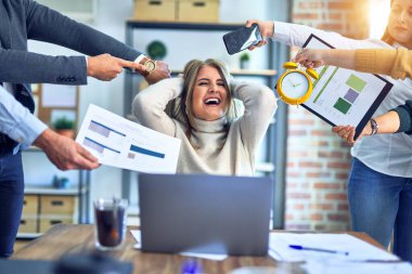Group of business workers working together. Partners stressing one of them at the office