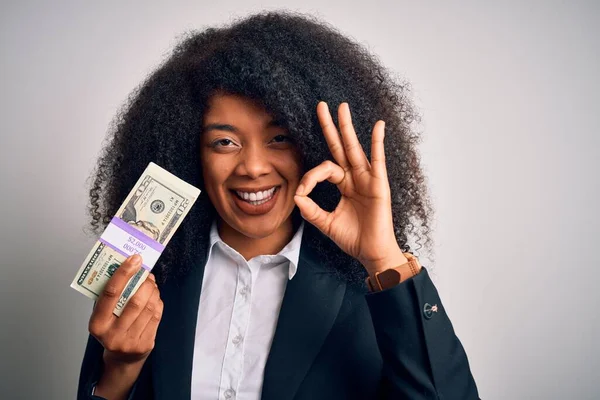20ドルの紙幣の束を保持しているアフロの髪を持つ若いアフリカ系アメリカ人のビジネス女性は指でOkサインをして 優れたシンボル — ストック写真