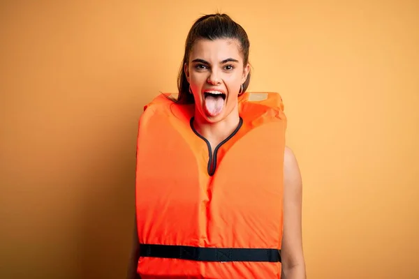 Junge Schöne Brünette Frau Orangefarbener Sicherheitsweste Über Gelbem Hintergrund Streckt — Stockfoto