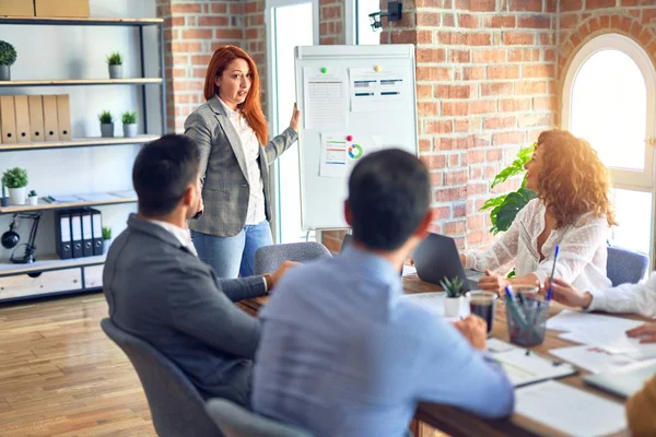 Group of business workers working together in a meeting. One of them making presentation to colleagues at the office