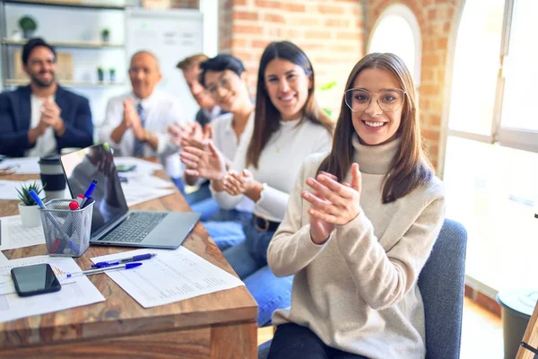 Group of business workers smiling happy and confident. Working together with smile on face looking at the camera applauding at the office