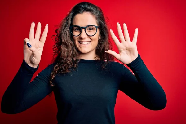 Young Beautiful Woman Curly Hair Wearing Sweater Glasses Red Background — Stockfoto