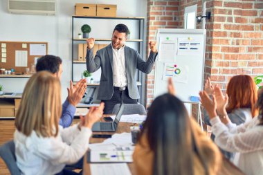 Group of business workers working together in a meeting. One of them making presentation to colleagues at the office