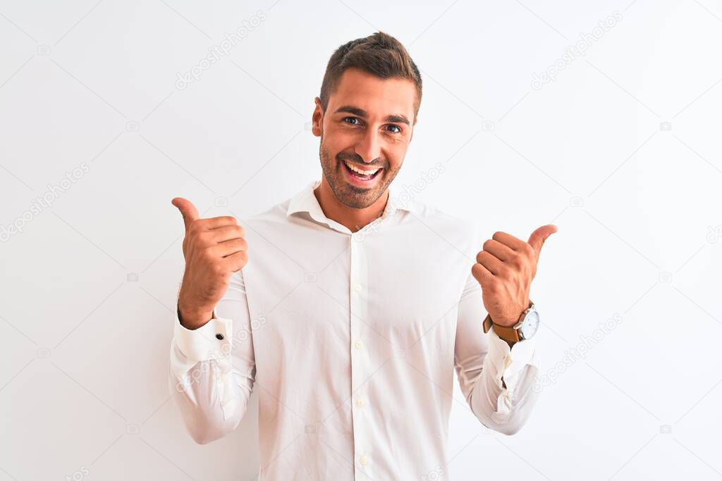 Young handsome business man wearing elegant shirt over isolated background success sign doing positive gesture with hand, thumbs up smiling and happy. Cheerful expression and winner gesture.