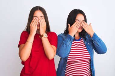 İzole edilmiş beyaz arka planda dikilen günlük kıyafetler giyen genç ve güzel kadınlar yorgunluk ve baş ağrısı için gözlerini ovuşturuyor, uykulu ve yorgun bir ifade takınıyorlar. Görüş sorunu