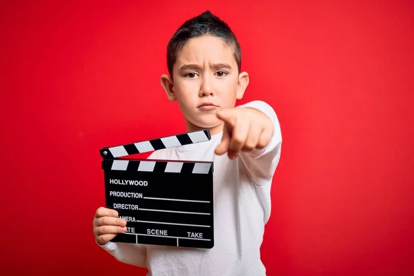 Młody Chłopiec Kręci Film Reżyserem Kina Clapboardem Odizolowanym Czerwonym Tle — Zdjęcie stockowe