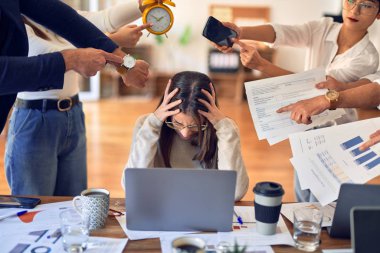 Group of business workers working together. Partners stressing one of them at the office