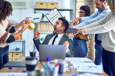 Group of business workers working together. Partners stressing one of them at the office