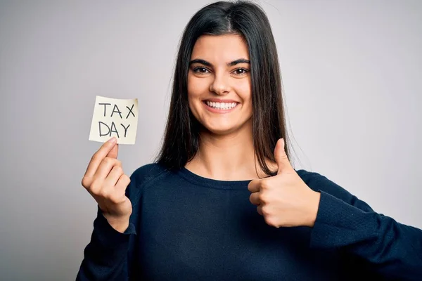 Young Beautiful Brunette Woman Holding Paper Reminder Paper Tax Day — Stockfoto