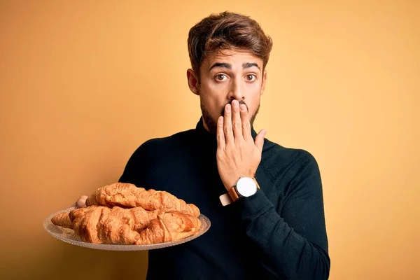 Young Man Beard Holding Plate Croissants Standing Isolated Yellow Background — Stock Photo, Image