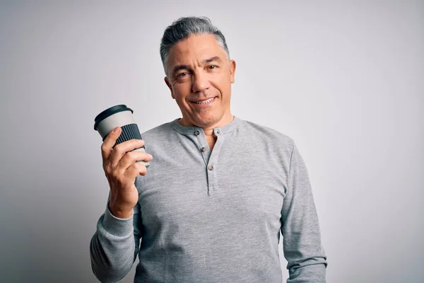 Middle age handsome grey-haired man drinking cup of coffee over isolated white background with a happy face standing and smiling with a confident smile showing teeth