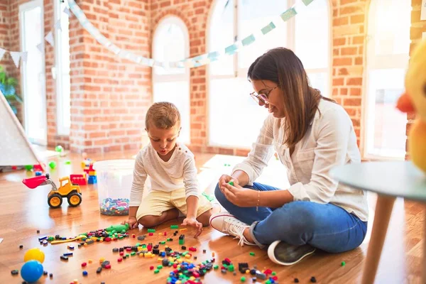 Beautiful Teacher Toddler Playing Building Blocks Lots Toys Kindergarten — Stock Photo, Image