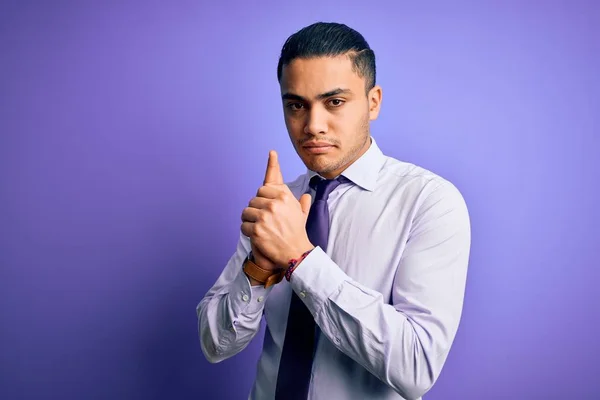 年轻的巴西商人 戴着精美的领带 站在孤立的紫色背景上 手握象征性的枪 玩着猎枪 怒气冲冲 — 图库照片