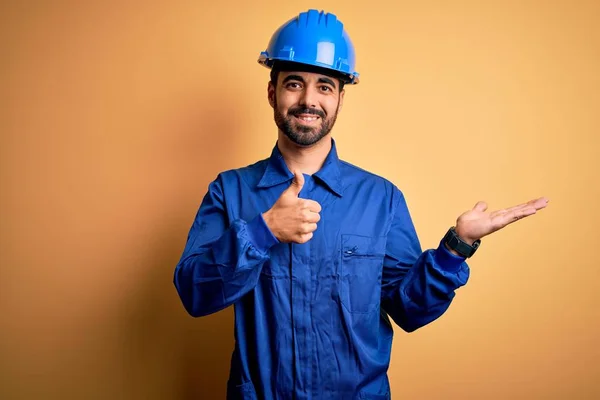 Mechanic Man Beard Wearing Blue Uniform Safety Helmet Yellow Background — Stock Photo, Image