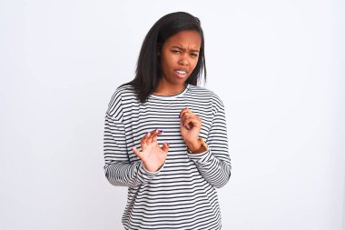 İzole arka plan üzerinde kış kazak giyen güzel genç Afro-Amerikan kadın tiksinti ifadesi, memnun ve korkulu tiksinti yüz yapıyorsun çünkü nefret tepki. Elleriyle kaldırdı. Sinir bozucu kavramı.