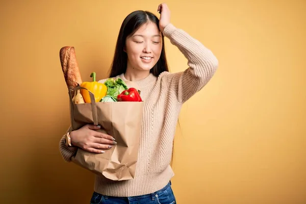 Young Asian Woman Holding Paper Bag Fresh Healthy Groceries Yellow — Stock Photo, Image