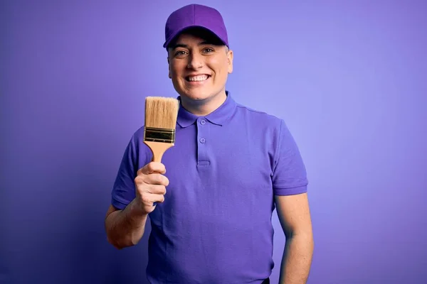 Young Modern Decorator Painter Man Holding Paint Brush Purple Background — Stock fotografie