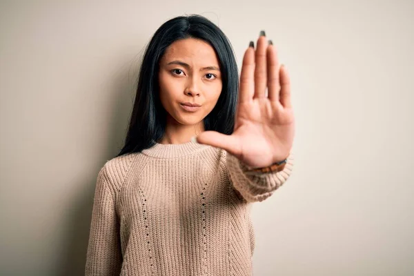 年轻美丽的中国女人穿着休闲装 披着孤立的白色背景 手牵着手唱着歌 脸上带有消极而严肃的手势的警告表情 — 图库照片