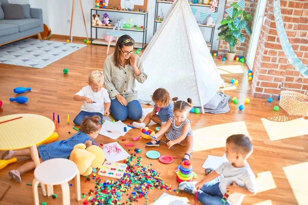 Vacker Lärare Och Grupp Småbarn Leker Runt Massor Leksaker Dagis — Stockfoto