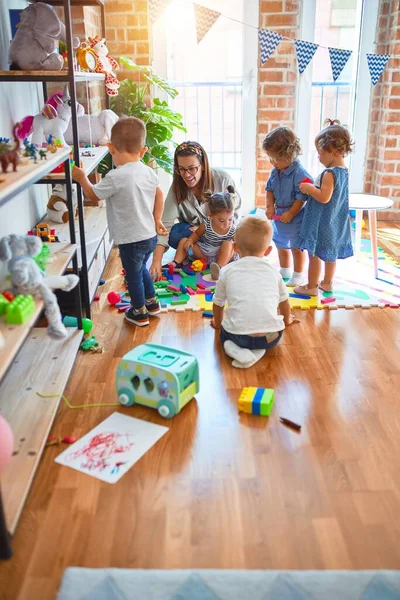 Schöne Lehrerin Und Kleinkindgruppe Spielen Kindergarten Viel Spielzeug — Stockfoto