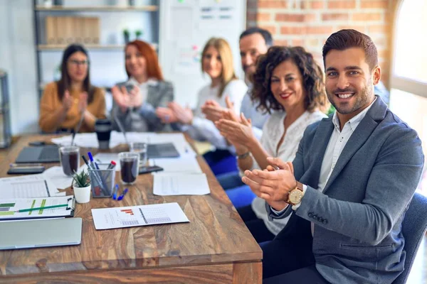 Group of business workers smiling happy and confident. Working together with smile on face looking at the camera applauding at the office