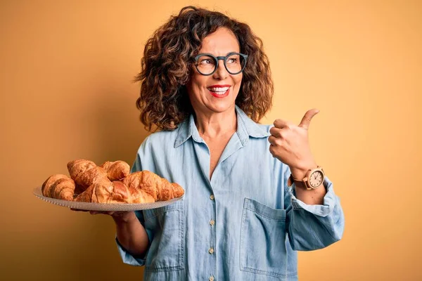 Středního Věku Krásná Žena Drží Talíř Croissanty Přes Izolované Žluté — Stock fotografie