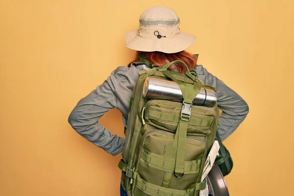 Young Redhead Backpacker Woman Hiking Wearing Backpack Hat Yellow Background — Stock Photo, Image