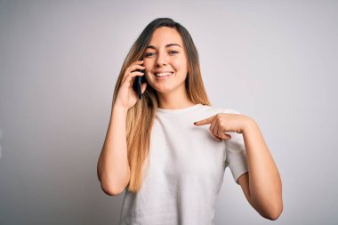 Genç, güzel, esmer bir kadın akıllı telefondan konuşuyor. Şaşırmış bir yüz ifadesiyle kendini işaret ediyor.