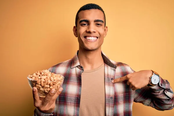 Snygg Afrikansk Amerikansk Man Håller Skål Med Heati Jordnötter Över — Stockfoto