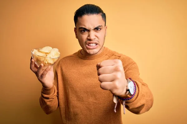 Young Brazilian Man Holding Bowl Chips Potatoes Isolated Yellow Background — Stock Photo, Image