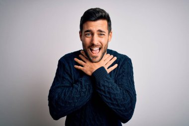 Sakallı, sıradan bir süveter giyen, beyaz arka planda durup bağıran ve boğulan genç yakışıklı bir adam. Çünkü acı verici bir boğulma. Sağlık problemi. Boğulma ve intihar konsepti.