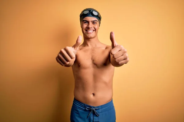 Young Handsome Man Shirtless Wearing Swimsuit Swim Cap Isolated Yellow — Stock Photo, Image