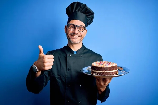 Young Handsome Baker Man Wearing Cooker Uniform Hat Holding Tray — Stock Photo, Image