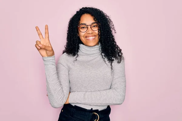Młoda Afroamerykanka Swetrze Golfem Okularami Różowym Tle Uśmiechnięta Szczęśliwą Twarzą — Zdjęcie stockowe