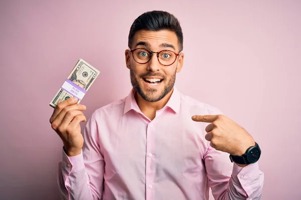 Joven Hombre Negocios Sosteniendo Montón Billetes Dólares Sobre Fondo Rosa —  Fotos de Stock