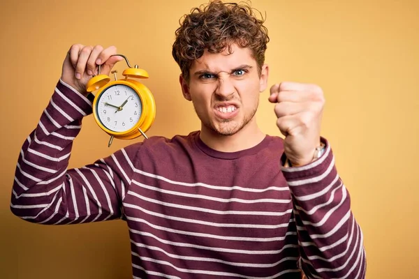 Young Blond Man Curly Hair Holding Alarm Clock Standing Isolated — Stock Photo, Image