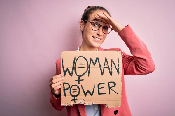 Young beautiful activist woman asking for women rights holding banner with power message stressed with hand on head, shocked with shame and surprise face, angry and frustrated. Fear and upset for mistake.