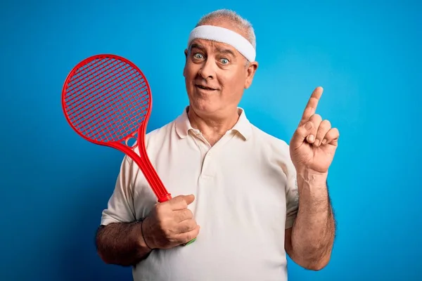 Middle Age Hoary Sportsman Playing Tennis Using Racket Isolated Blue — Stock Photo, Image