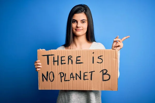 若い美しいブルネットの活動家の女性は 地球をケアするために抗議するバナーを保持します非常に幸せなポイントで手と指で側に — ストック写真